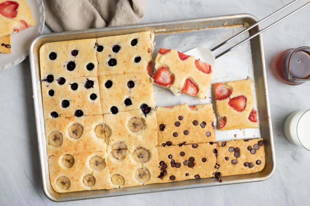 Pancakes made in a sheet pan cut into 12 squares with four different toppings