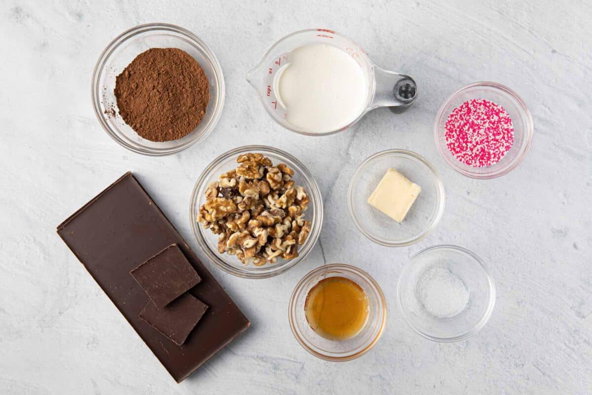 Ingredients before prepped: chocolate bar, heavy cream, unsalted butter and hone plus optional toppings: cocoa powder, sprinkles, and walnuts.