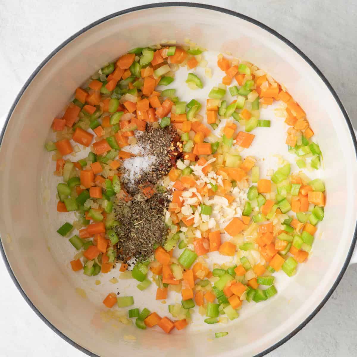 Onions, carrots and celery after cooking in Dutch oven with fresh garlic and seasonings added.