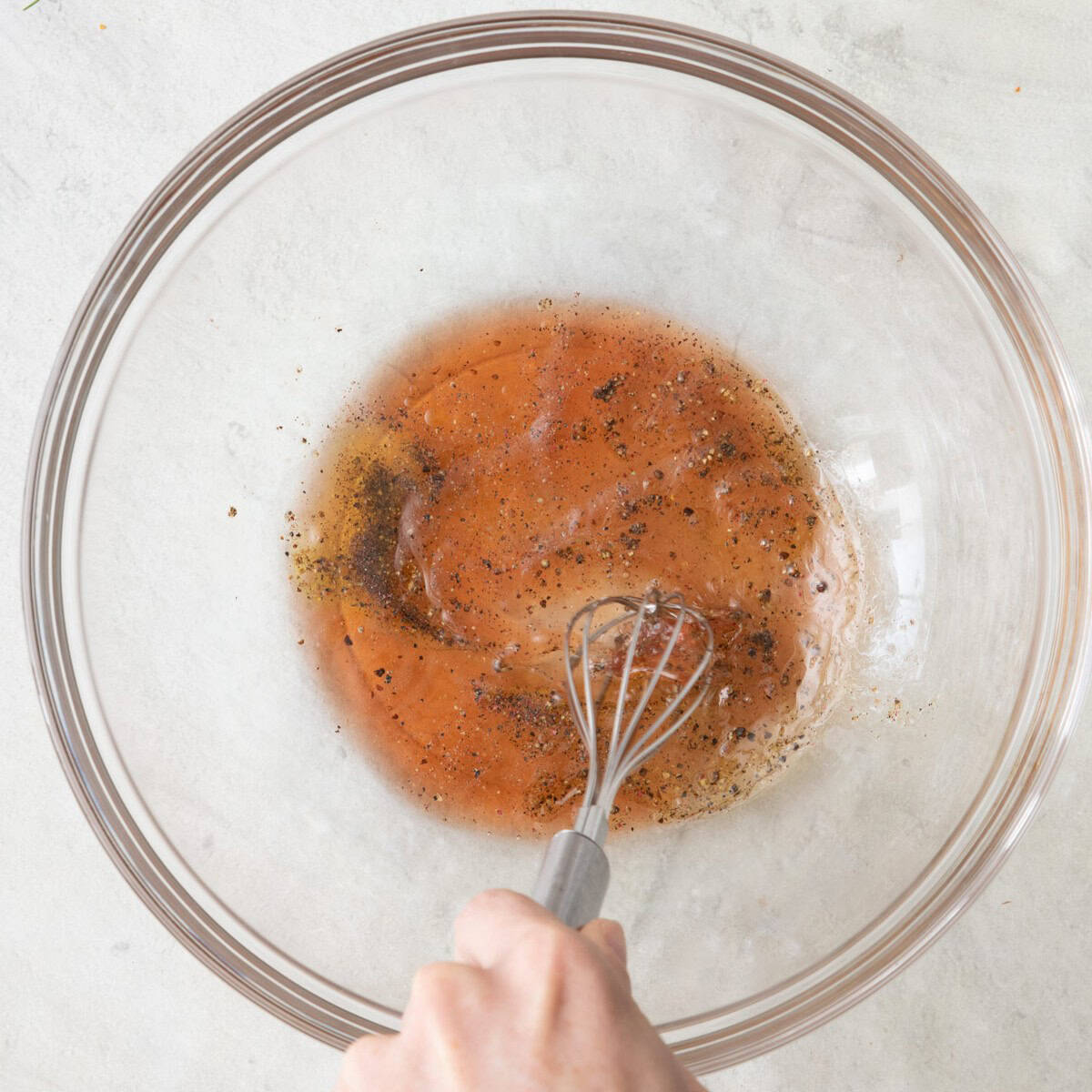 Whisking dressing ingredients together.