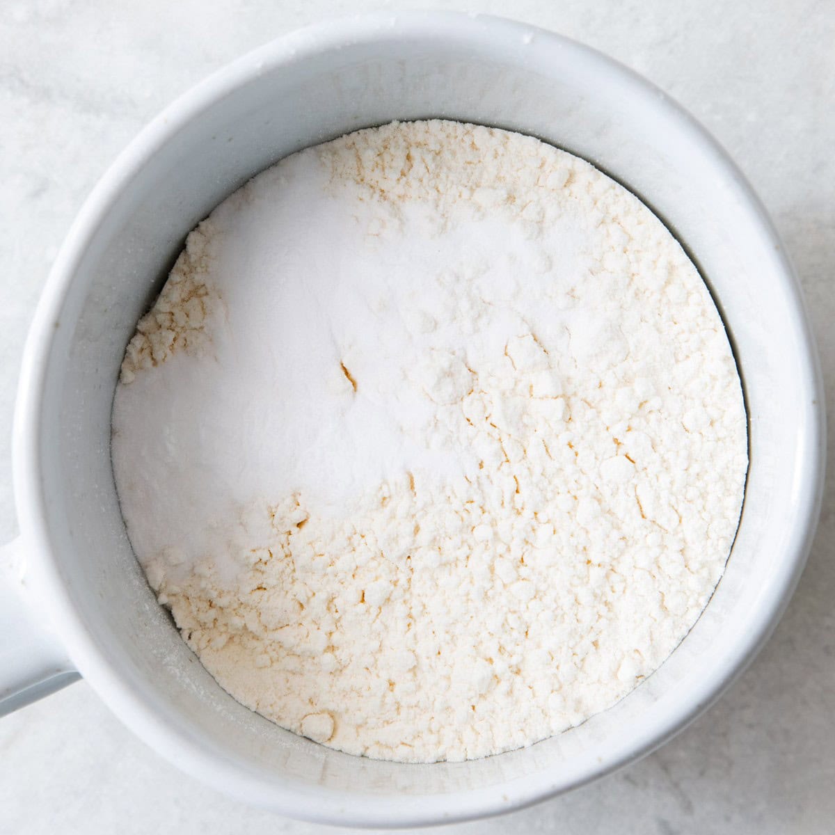 Dry ingredients for a vanilla mug cake in a mug.