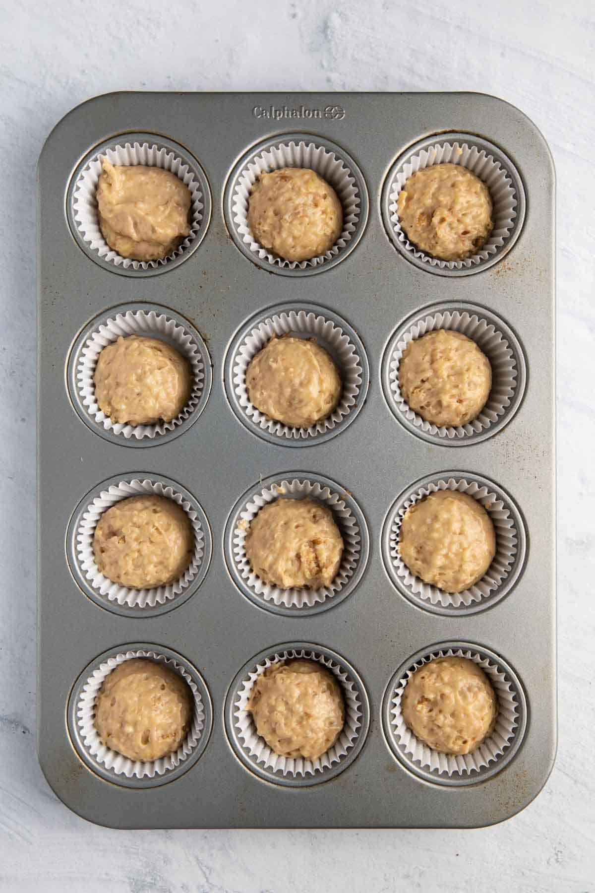 Muffins in muffin tin before baking.