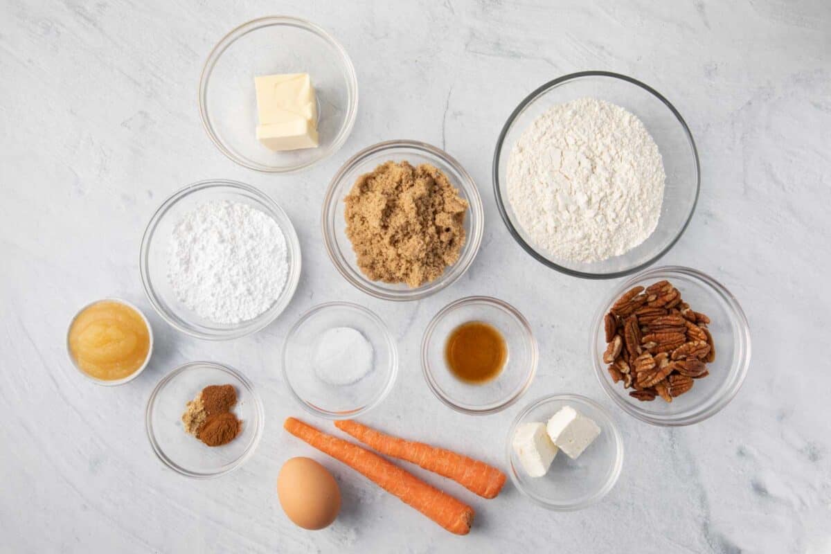 Ingredients for recipe: flour, spices, baking soda, salt, butter, brown sugar, apple sauce, egg, vanilla extract, carrots, and pecans. Plus frosting ingredients, cream cheese, powdered sugar, and milk.