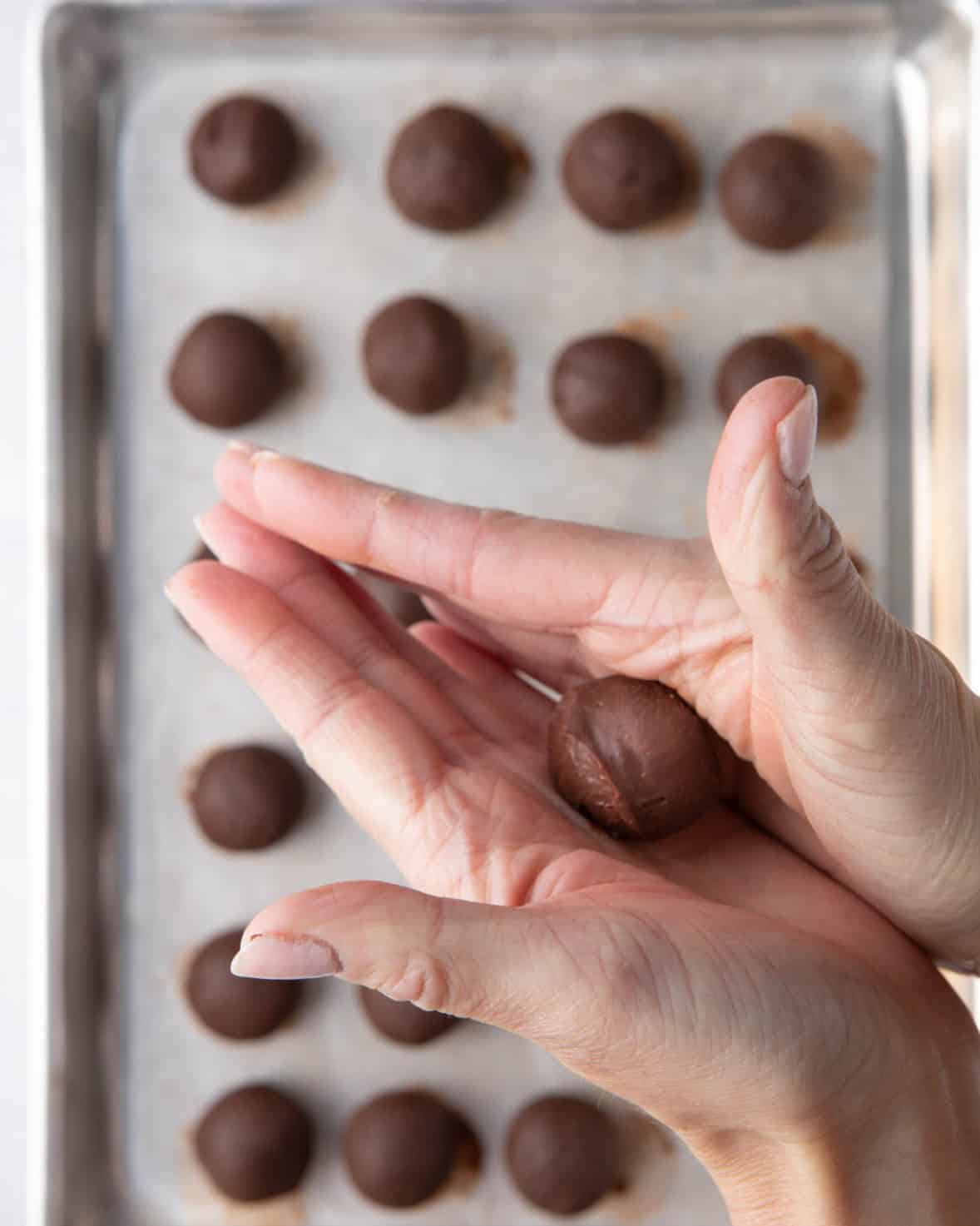 One cold ganache getting rolled into a ball.