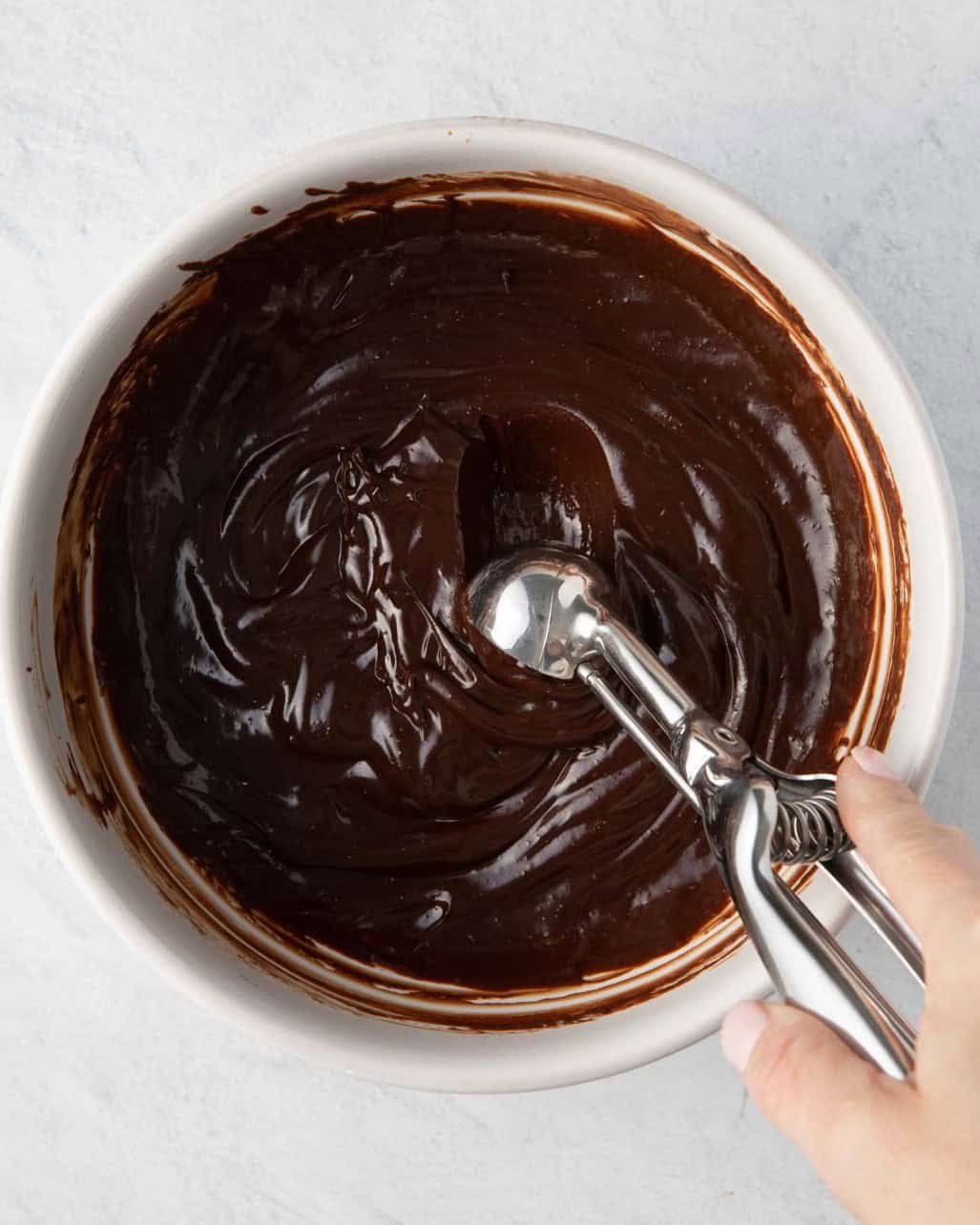 Tablespoon scooping up ganache.
