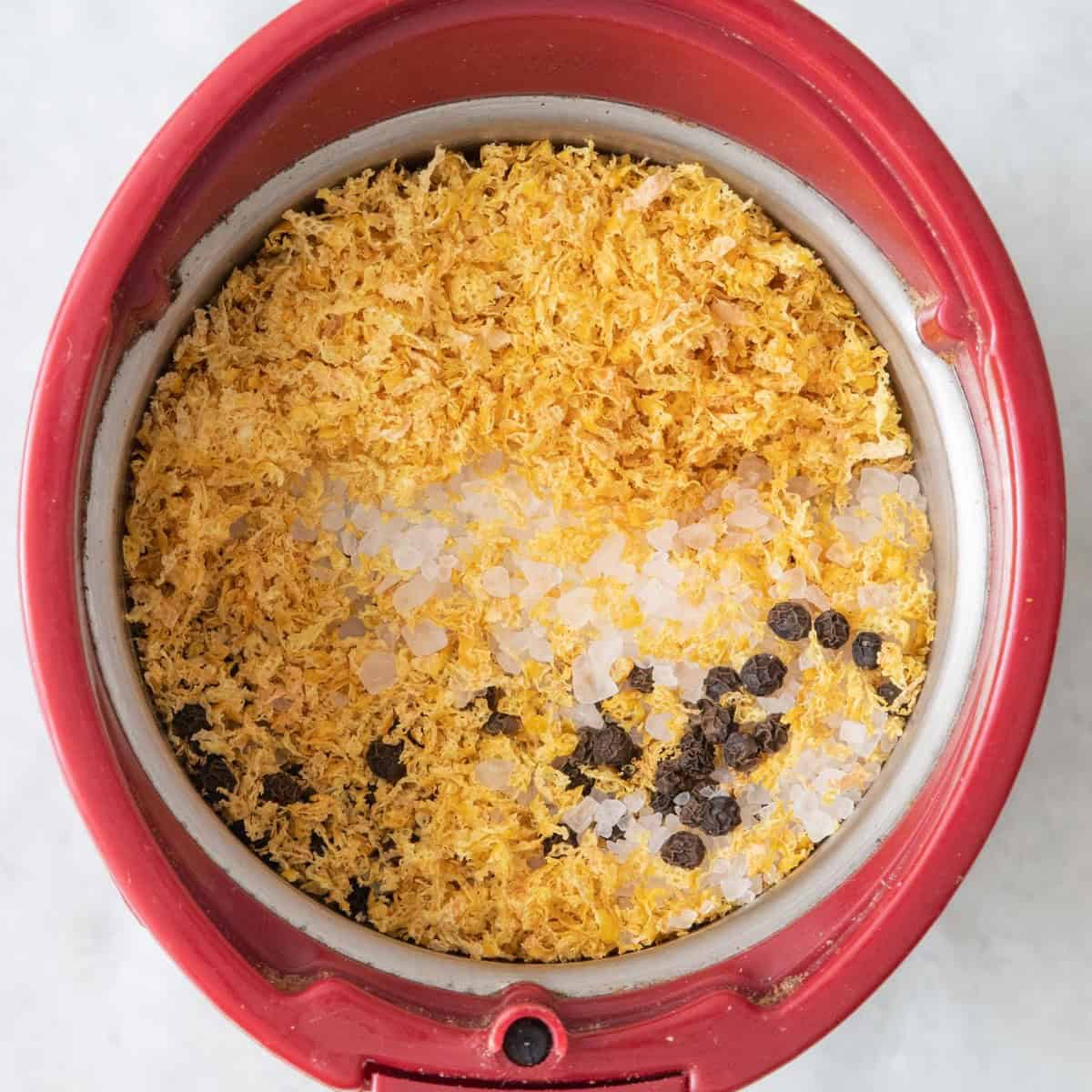 Dried lemon zest, peppercorns, and salt in a spice grinder (or blender) before pulsing.
