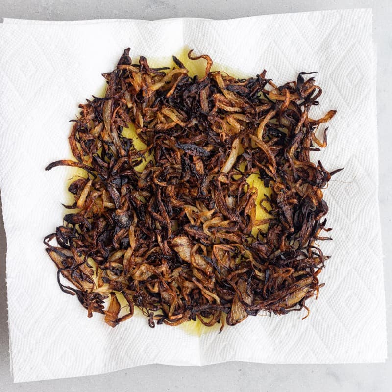 Cooked onions on a paper towel.