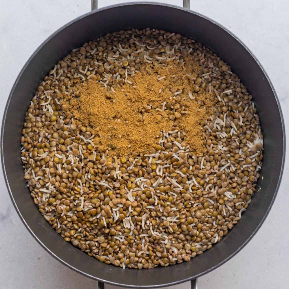 Cumin sprinkled onto the lentils and rice mixture.