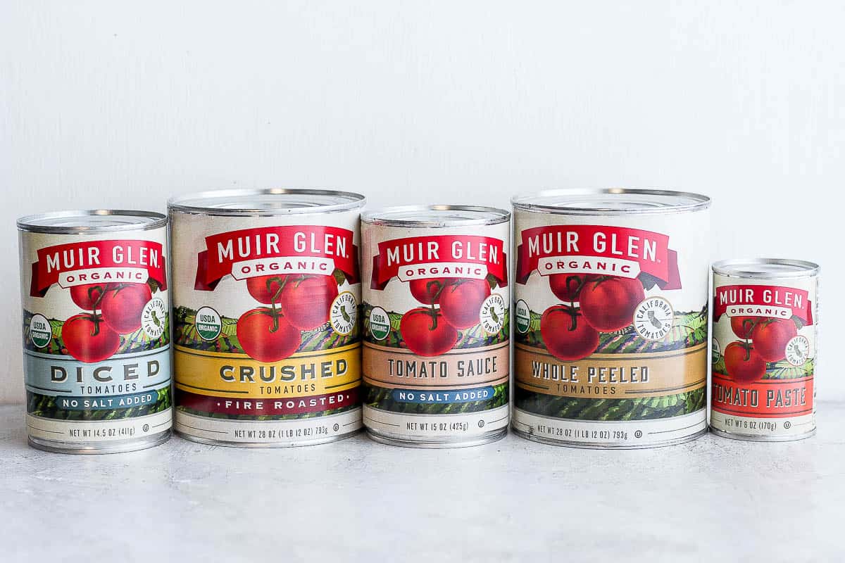 5 different types of canned tomatoes: diced, crushed, sauce, whole peeled, and paste.