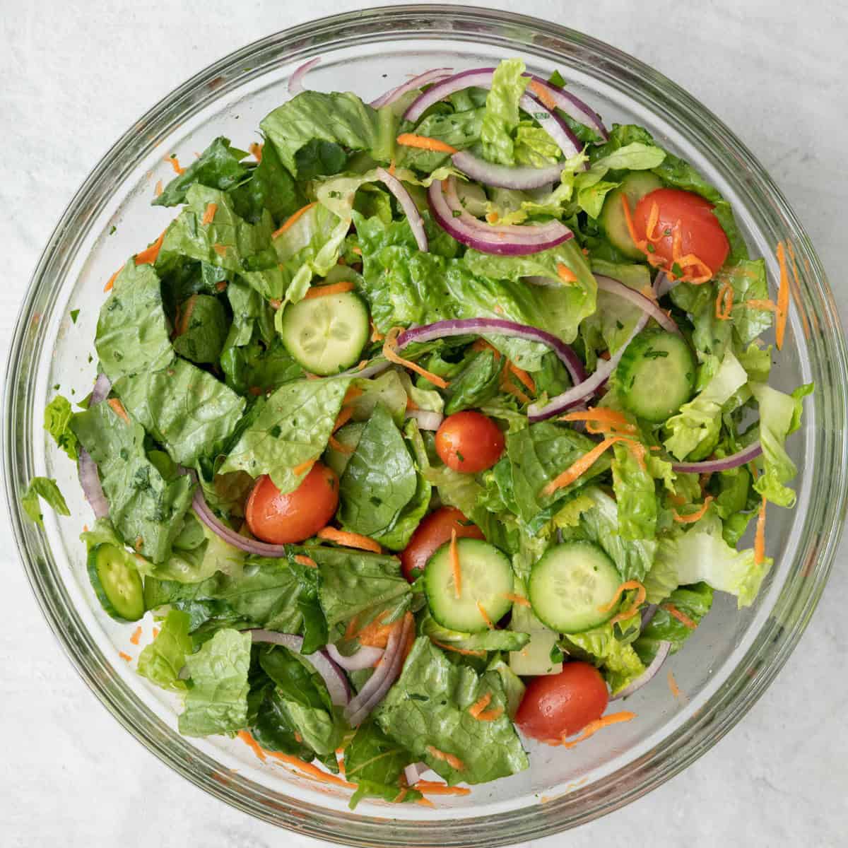 Salad after tossed with dressing to show it coated over all the ingredients.