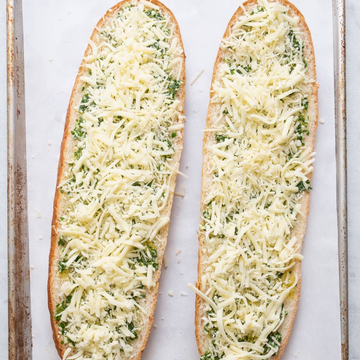 The bread is covered in mozzarella and parmigiano reggiano.