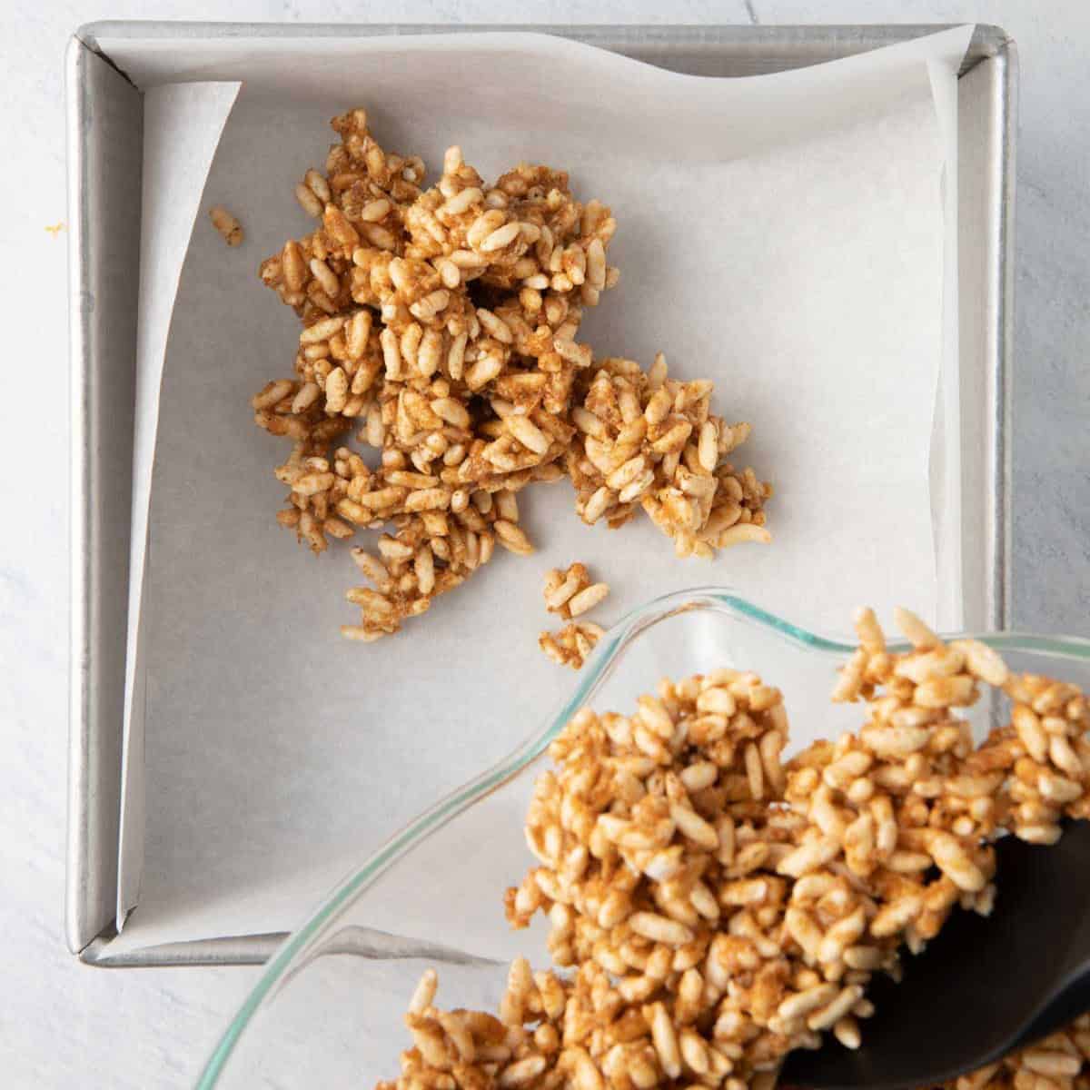 A spatula scraping the rice mixture into prepared pan.