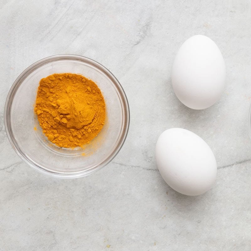 Ingredients to make yellow dyed eggs.