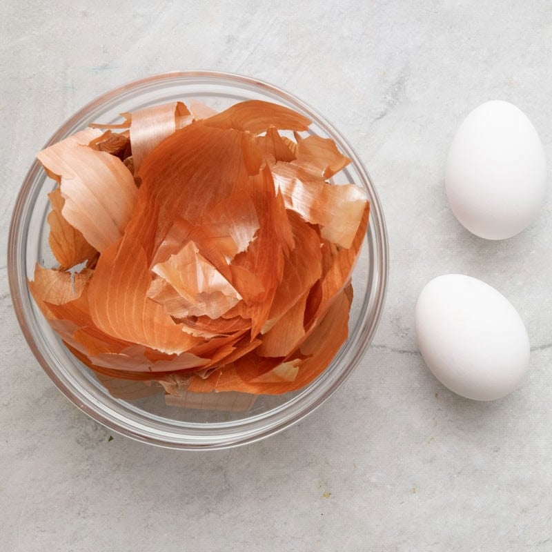 Ingredients to make orange dyed eggs.