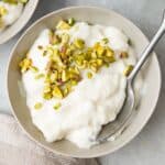 Ashta in a bowl with a spoon lifting some up.
