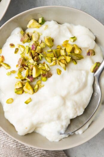 Ashta in a bowl with a spoon lifting some up.