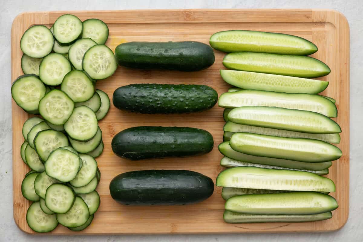 Cucumbers cut into spears, whole, and slices.