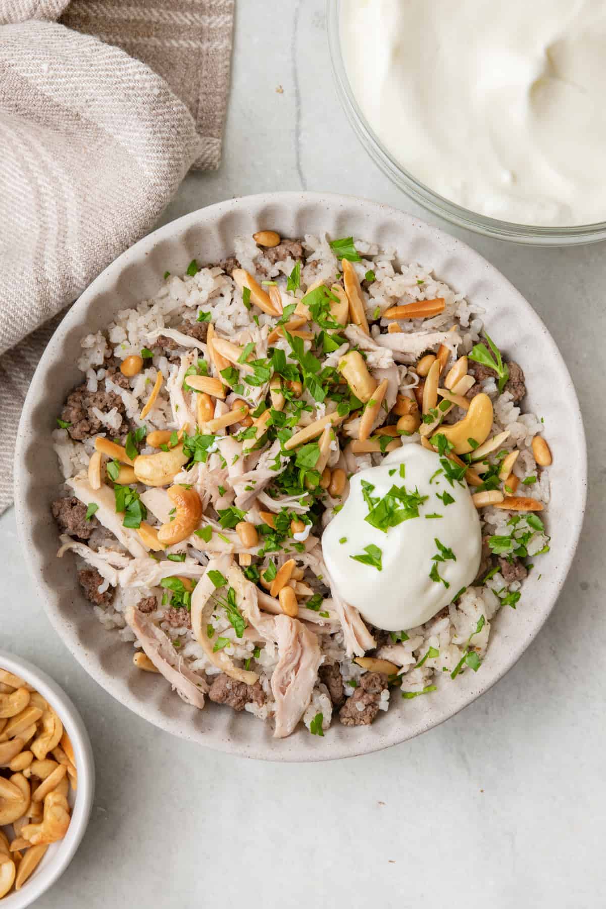 Lebanese chicken and rice topped with toasted nuts, homemade yogurt, and fresh herbs.