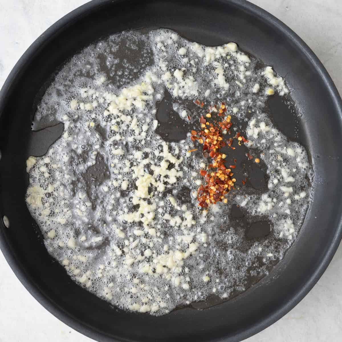 Remaining butter, garlic and red pepper flakes .