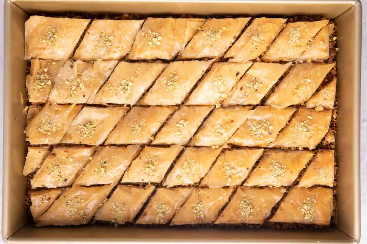 Baklava with pistachios on top of each piece.