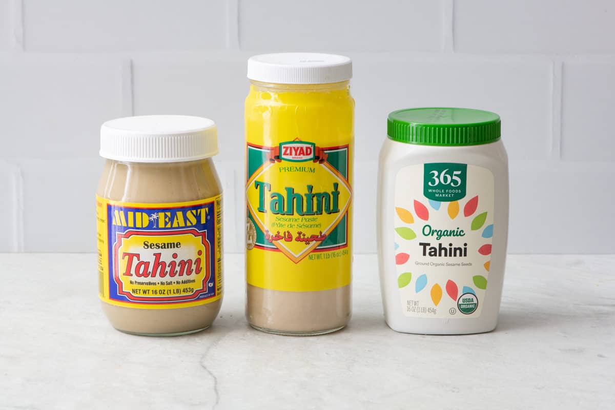 3 jars of tahini from different brands.