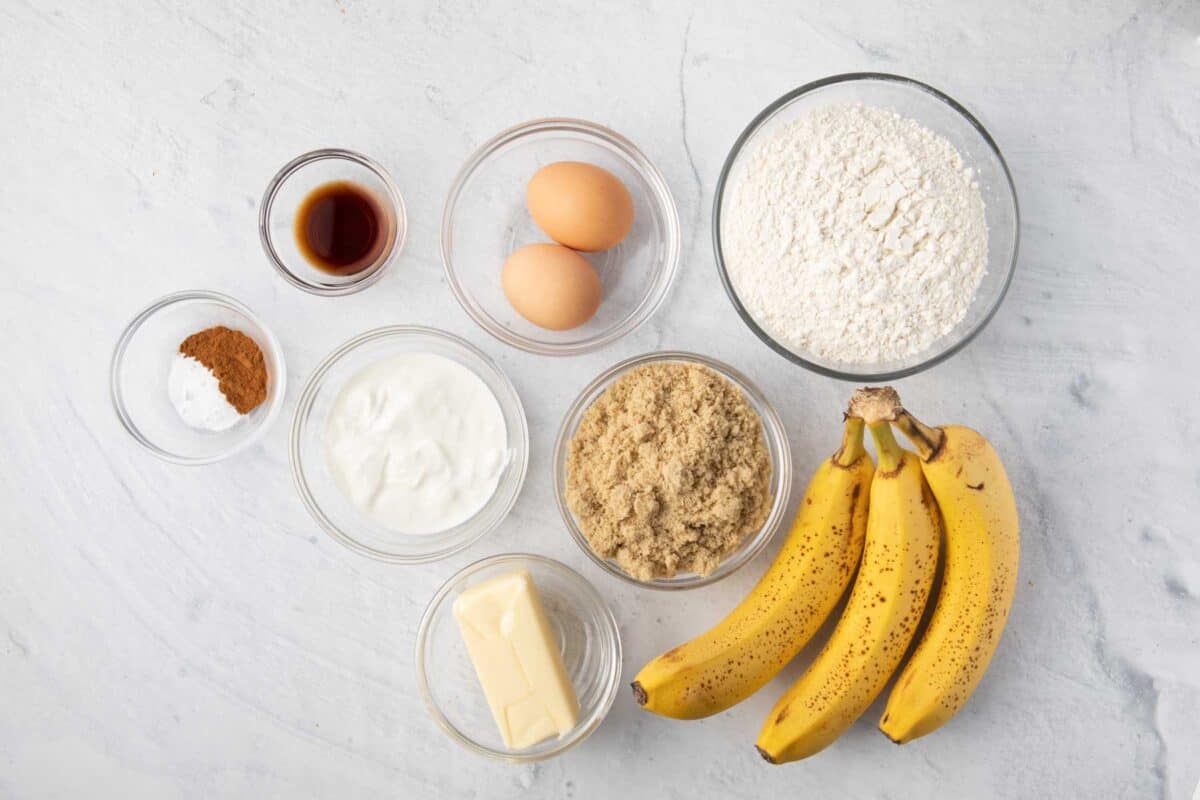 Ingredients for recipe: bananas, flour, brown sugar, butter, yogurt, eggs, vanilla, baking powder, and cinnamon.