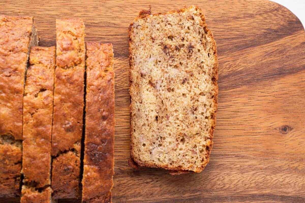 Close up of a slice of banana bread with a few slices from the loaf.