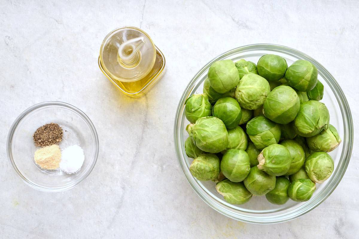 Ingredients for recipe before prepping: salt, pepper and garlic powder, oil, and brussel sprouts.