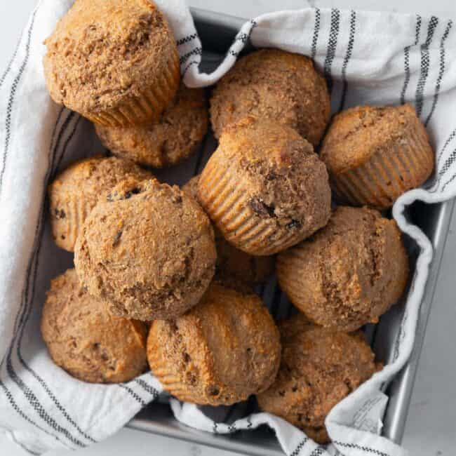 Bran muffins in a cloth lined pan.