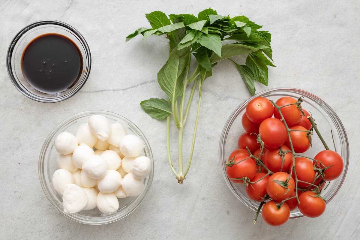 Ingredients for recipe: balsamic glaze, fresh mozzarella, basil, and tomatoes.