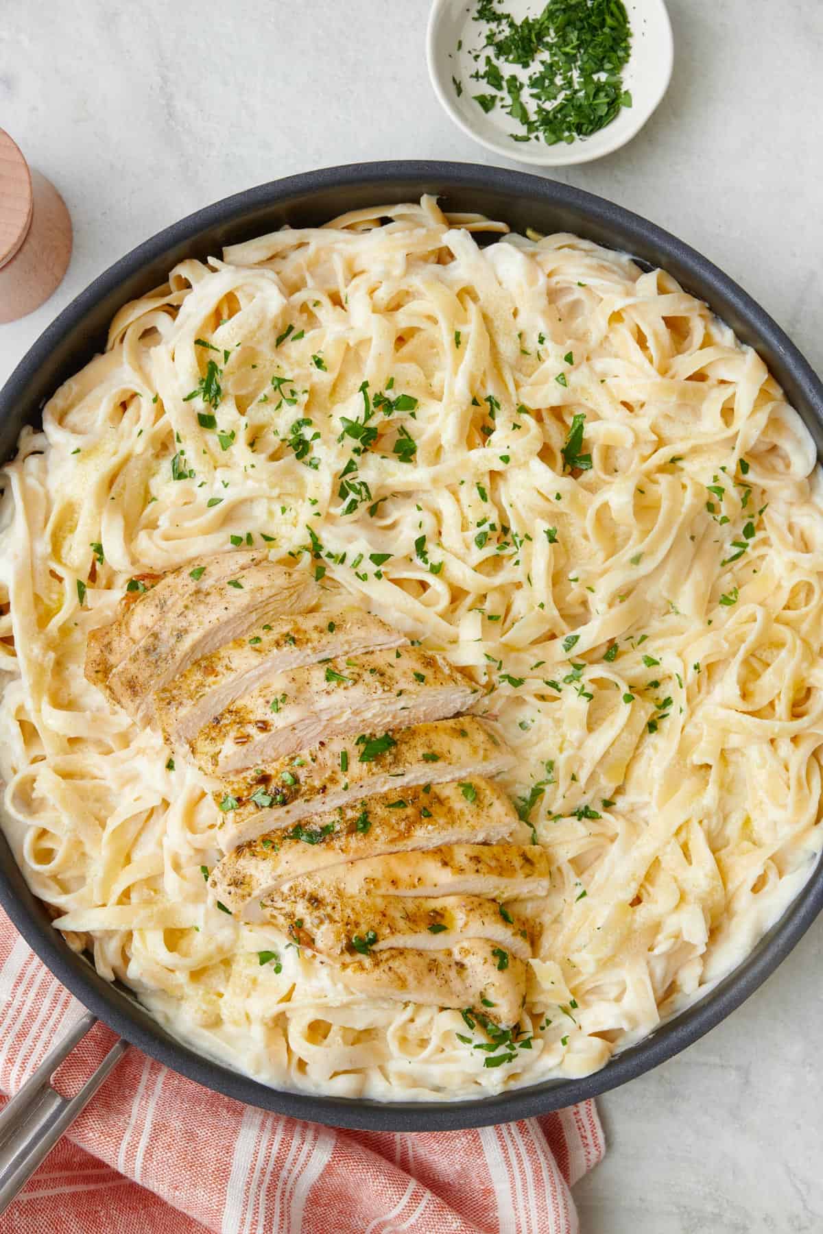 Two bowls of fettuccine alfredo and forks