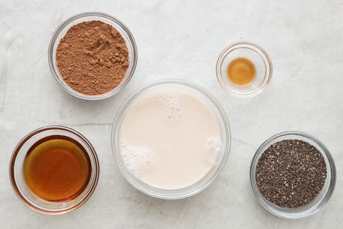 Process shots showing the maple syrup and vanilla extract getting added to cocoa powder and then getting mixed.