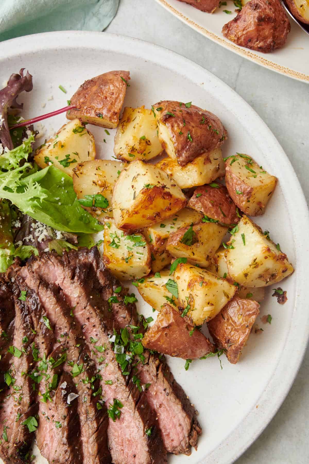  Garlic Parmesan Roasted Potatoes in a white serving dish 