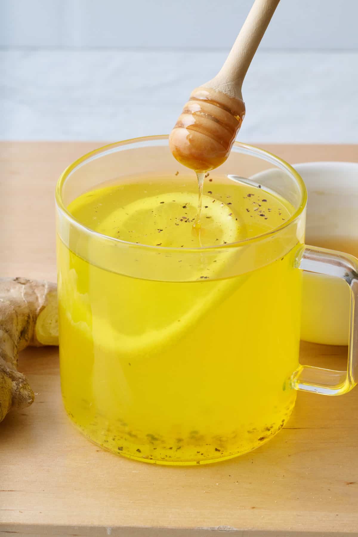 Honey being drizzled into Ginger Turmeric Tea