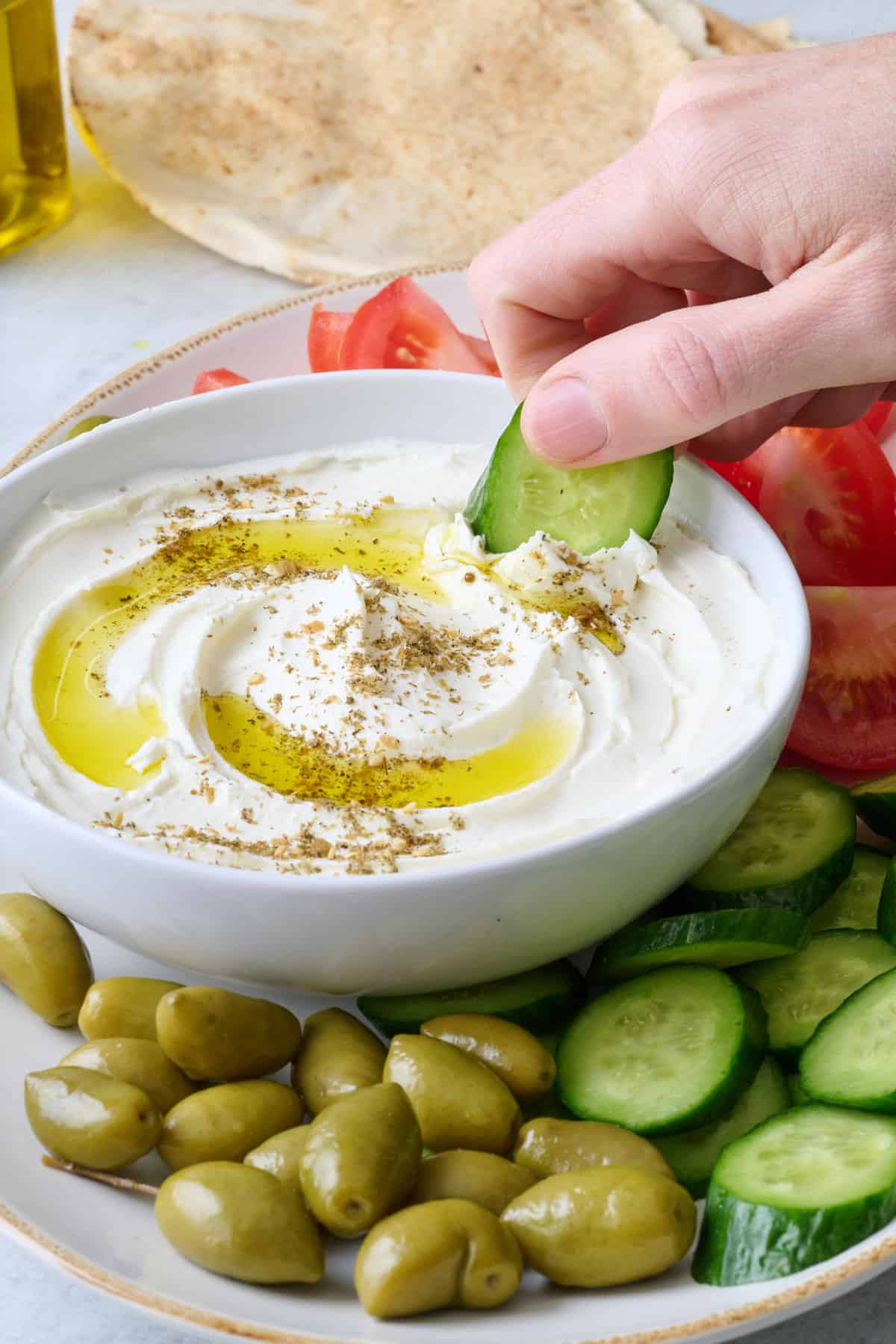 Labneh spread in a bowl with olive oil and zaatar