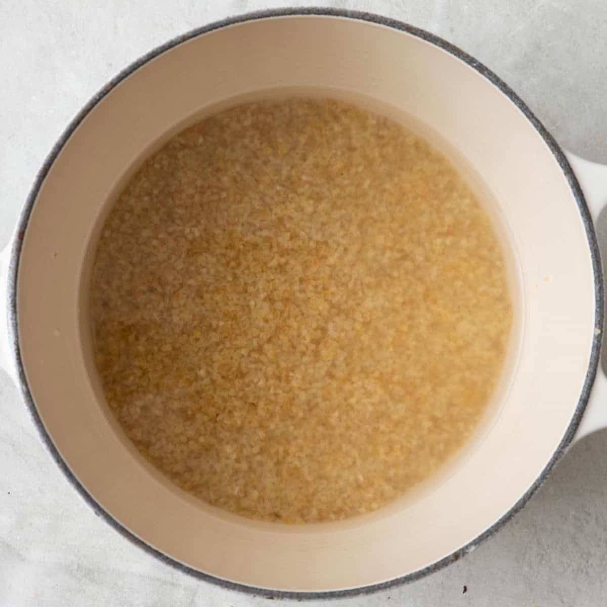 Bulgur in a pot with water.