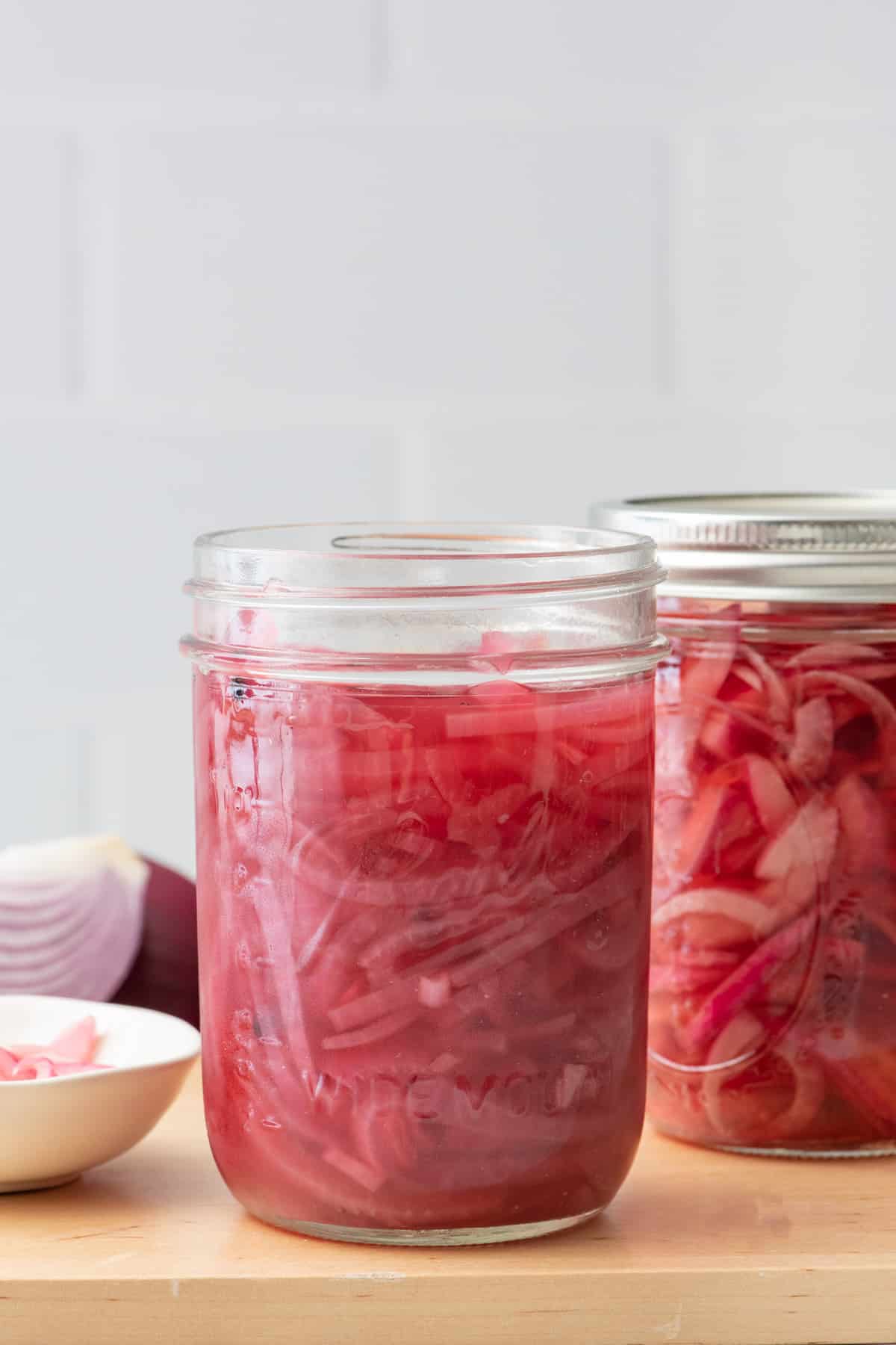 Pickled onions in a clear mason jar