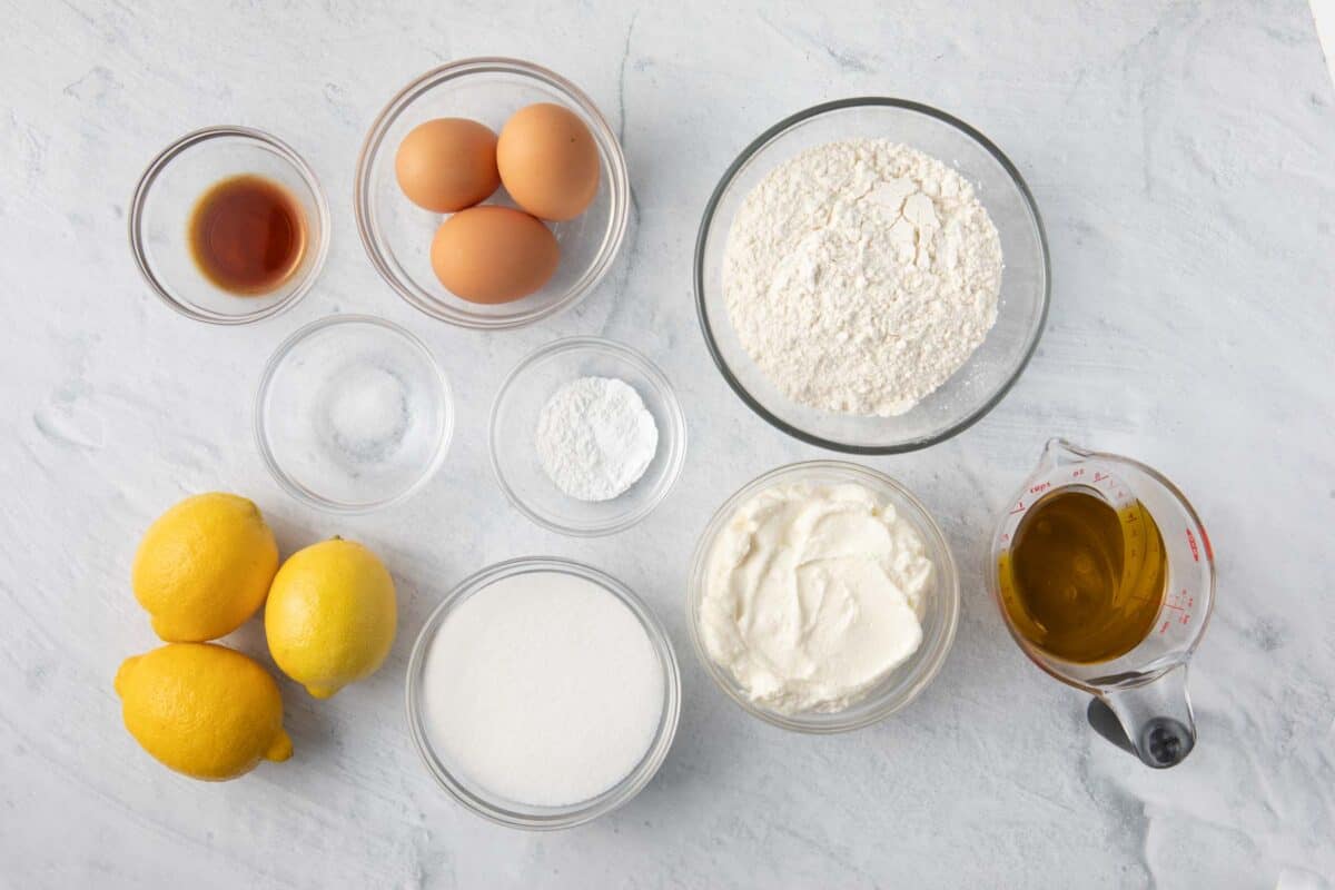 Ingredients for recipe before being prepped: vanilla, eggs, salt, lemons, baking powder, sugar, flour, ricotta, and oil.