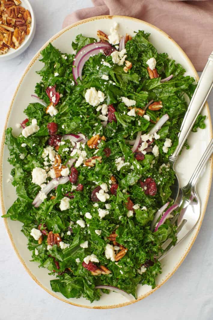 Massaged kale salad with sliced onions, feta, dried cranberries and toasted pecans.