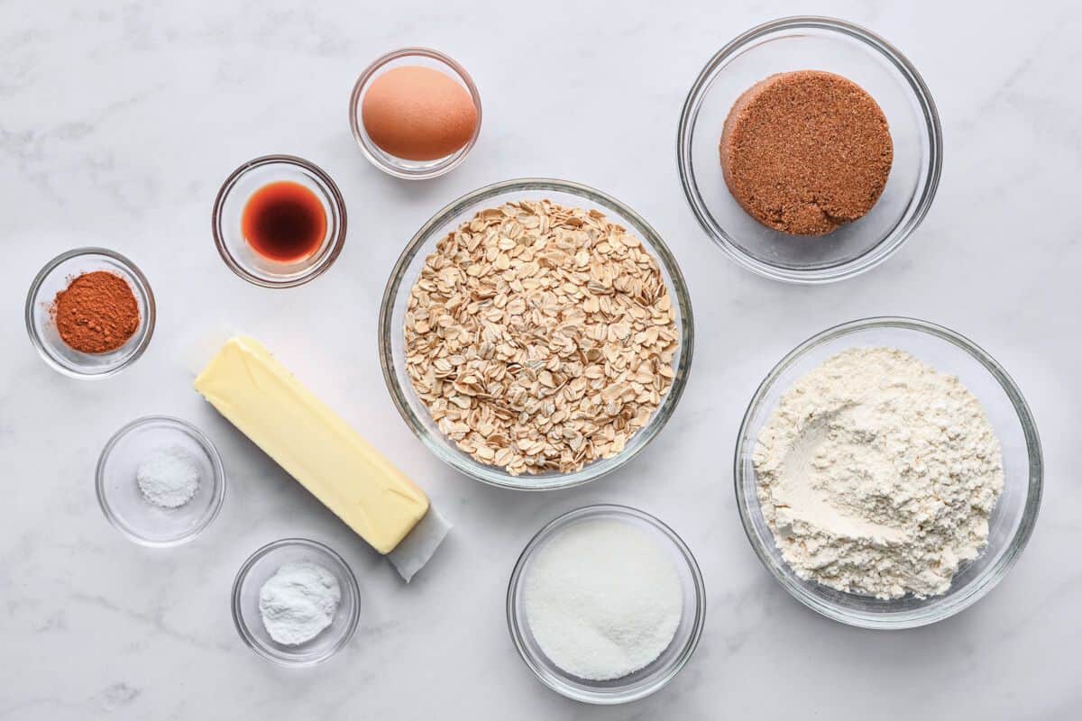Ingredients for recipe: oats, butter, sugar, vanilla, cinnamon, salt, baking soda, an egg, brown sugar, and flour.
