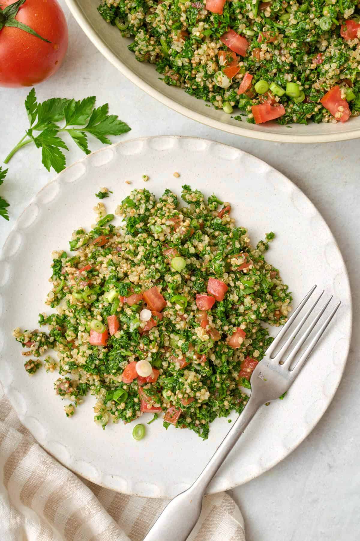 Plate of the of final quinoa tabbouleh recipe garnished with green onions.