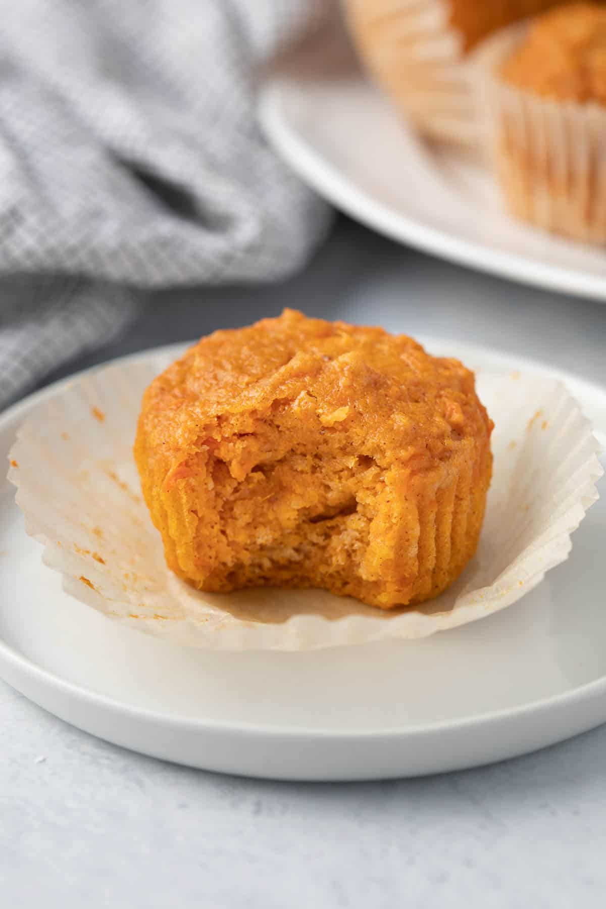 Close up of on sweet potato muffin cut in half to show moist texture