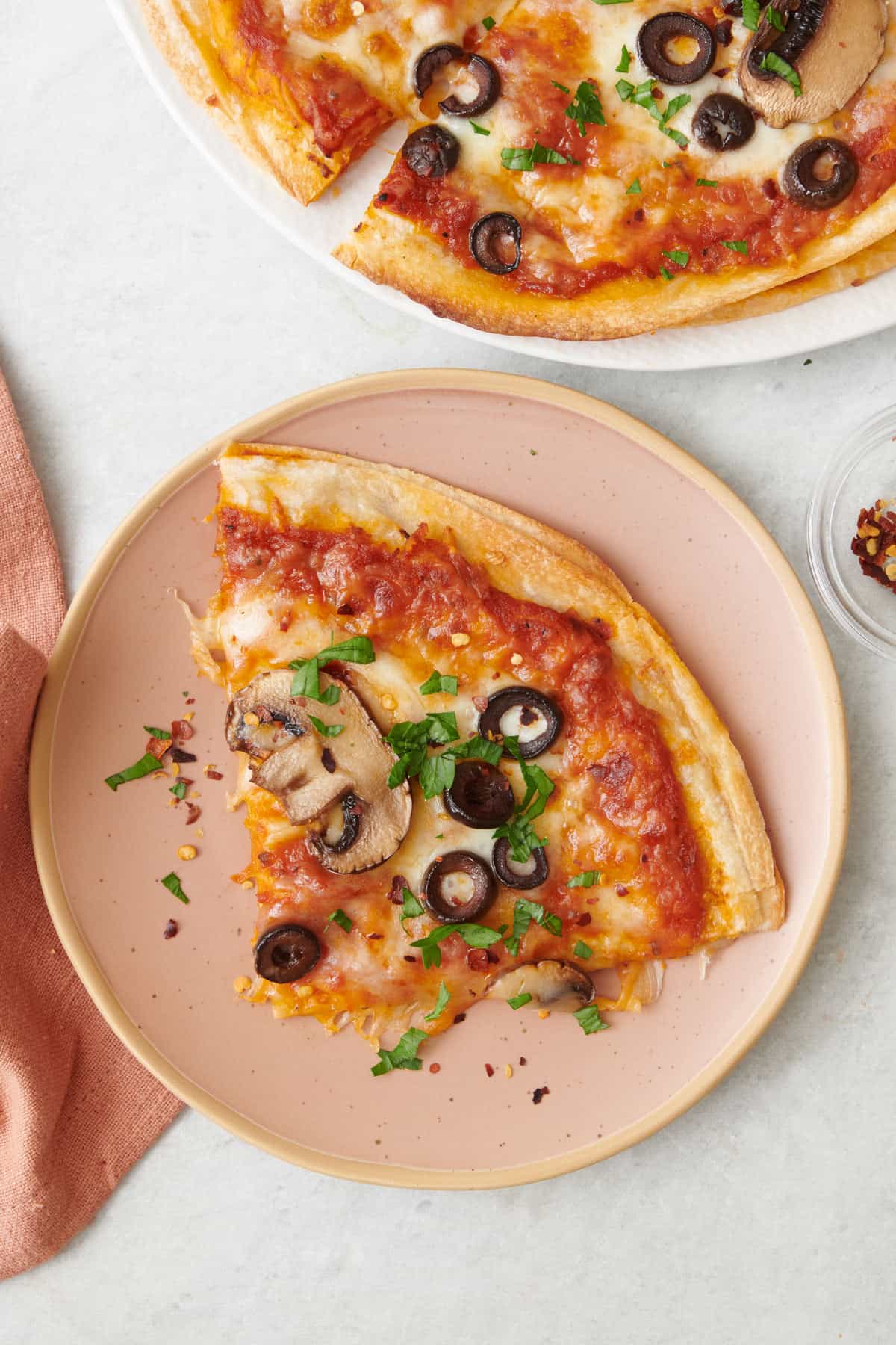 Vegetarian tortilla pizza sliced into four slices