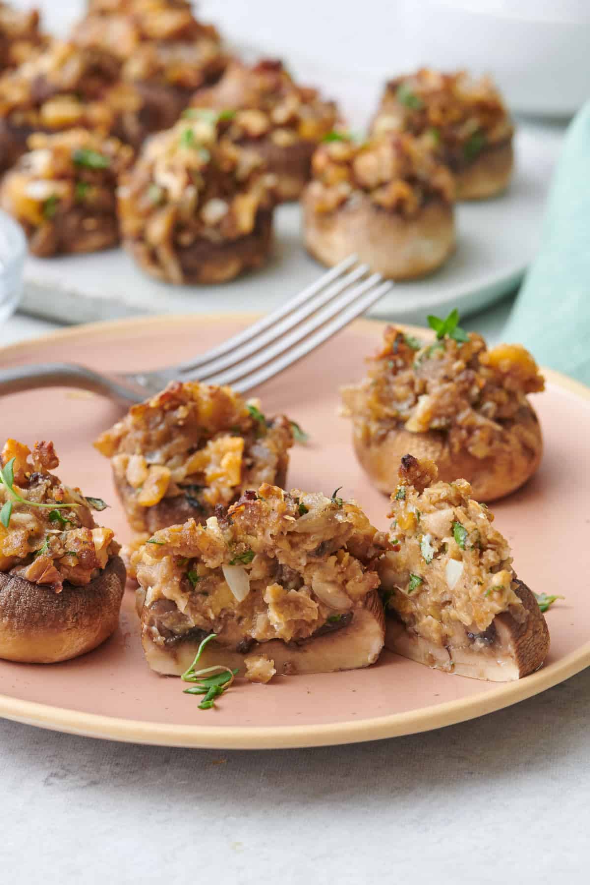 Vegetarian stuffed mushrooms on a dish garnished with rosemary