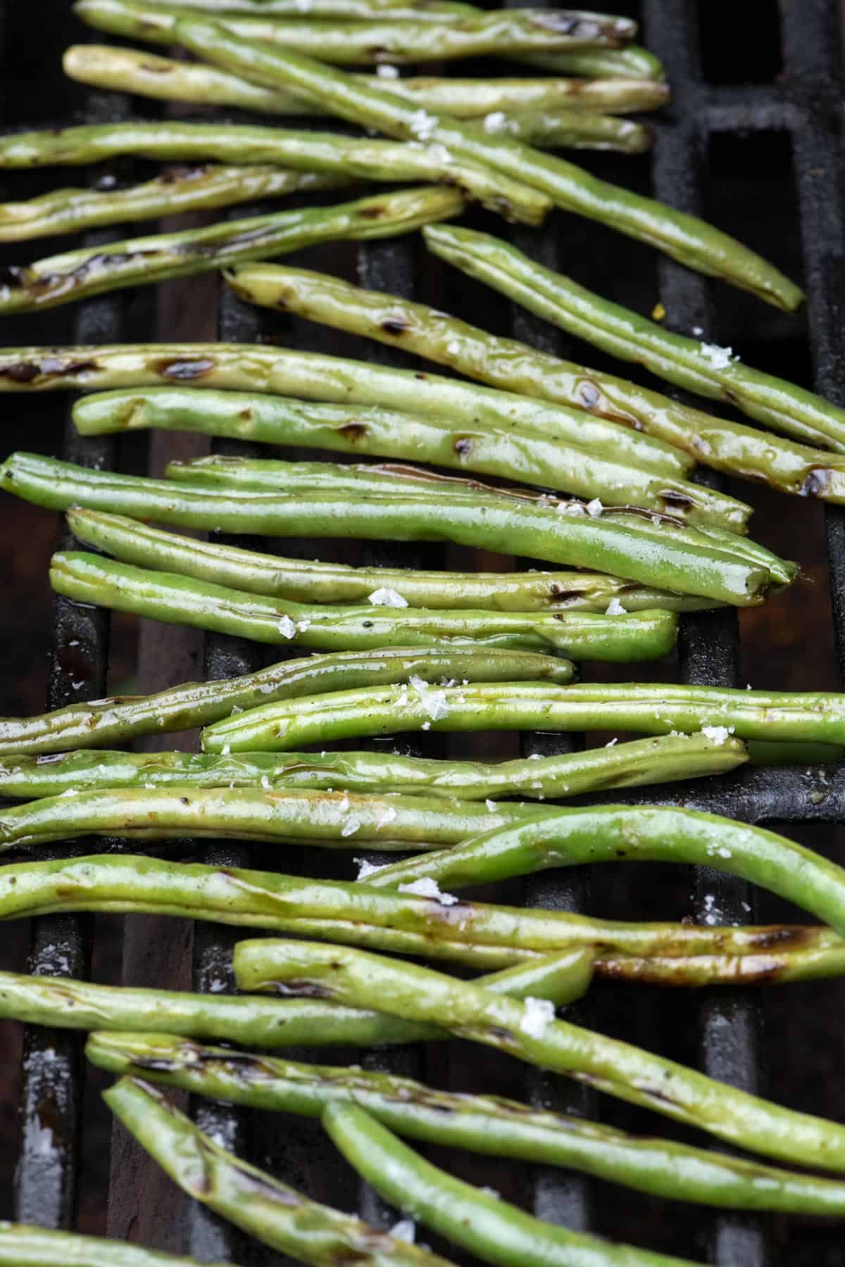 Fresh green beans on the grill with flaky salt.