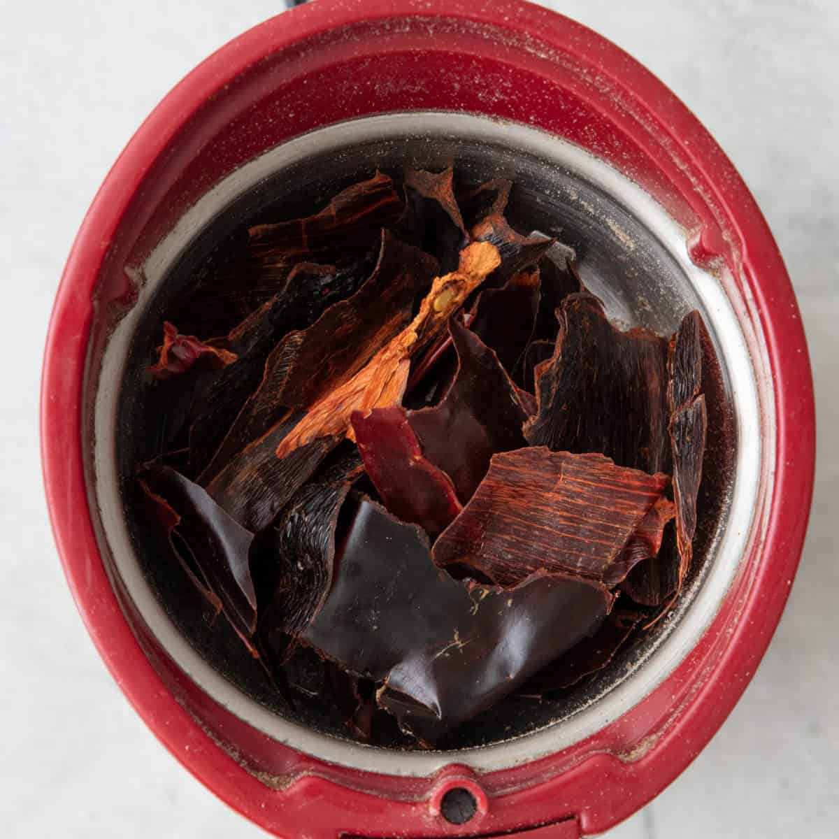 Chili peppers in a spice grinder before grinding.