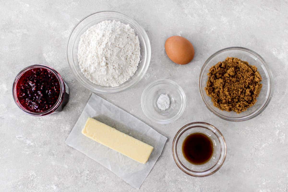 Ingredients for recipe: jam, flour, butter, salt, egg, vanilla, and brown sugar.