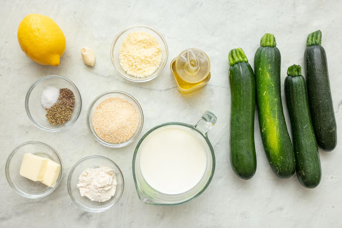 Ingredients for recipe: zucchini, lemon, seasoning, parmesan cheese, garlic, panko breadcrumbs, butter, flour, and milk.