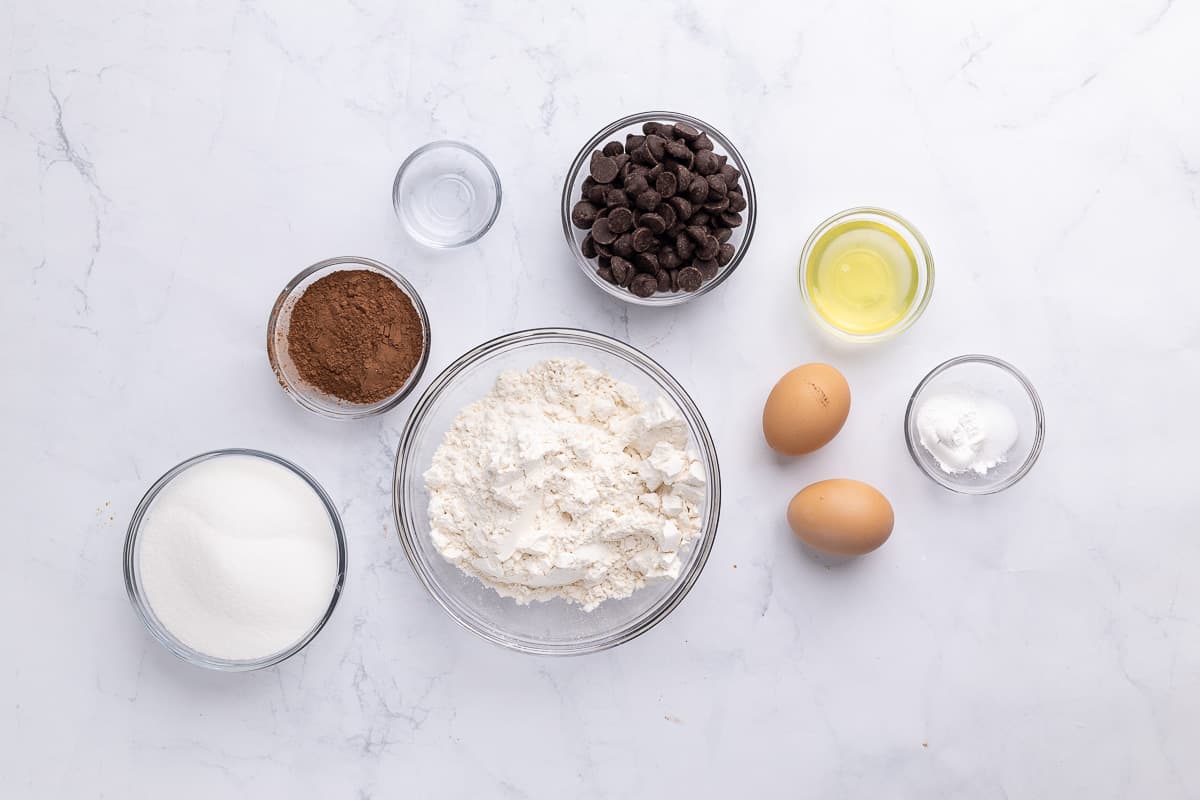 Ingredients for recipe: sugar, cocoa powder, flour, chocolate chip, extract, eggs, and rising agents.