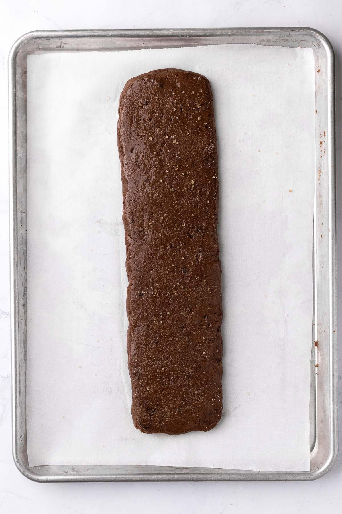 Biscotti before baking egg wash on top and sugar sprinkled on top.